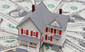 Graphic of House sitting on stack of money