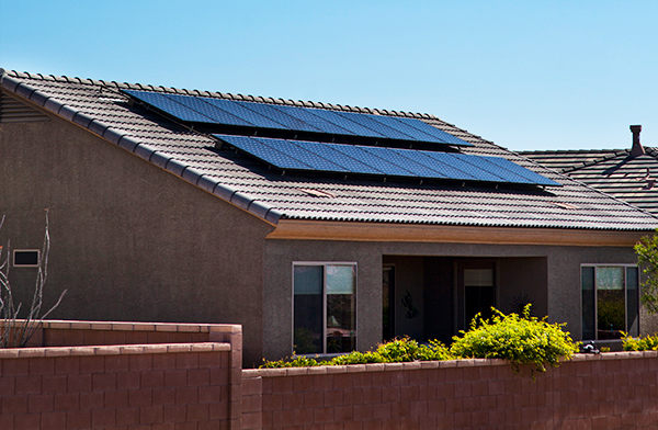 Photo of solar panels on red tile roofed house