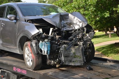Photo of car with smashed front end on tow truck